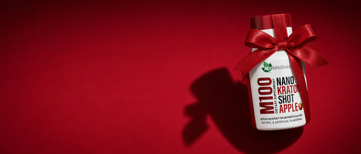 a bottle with a red ribbon