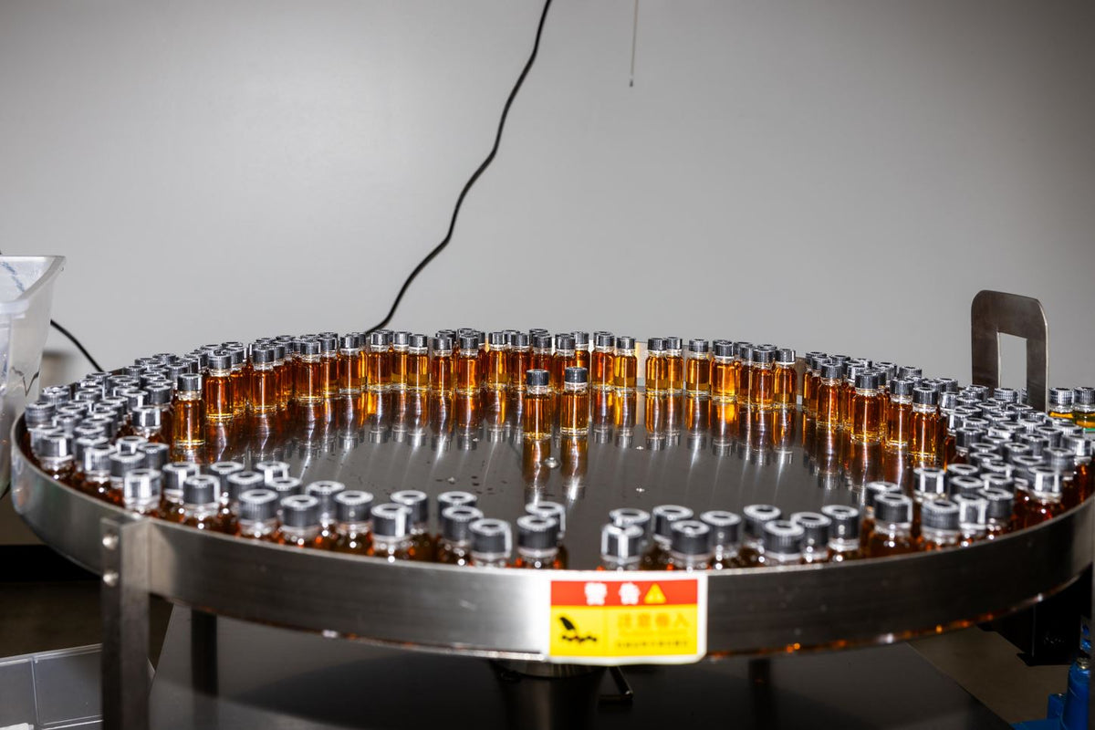 a group of small bottles on a circular metal surface