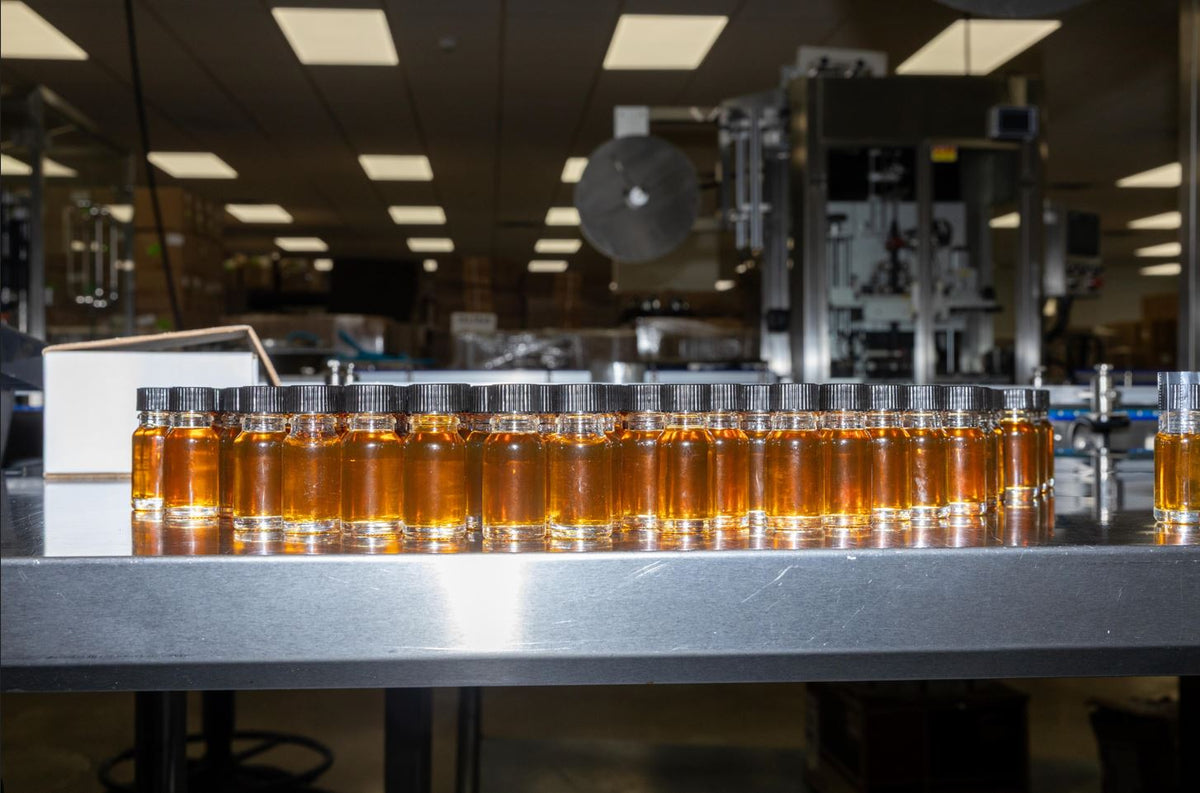 a row of small bottles with amber liquid in them