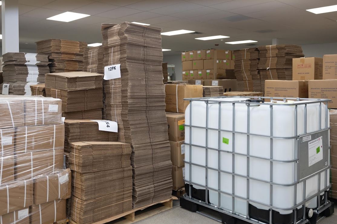 a large warehouse with stacks of cardboard boxes